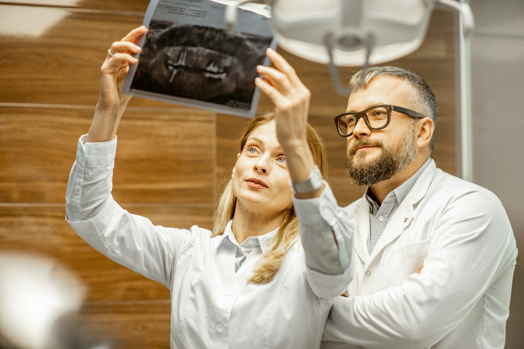 Dentists examining x-ray image at the office
