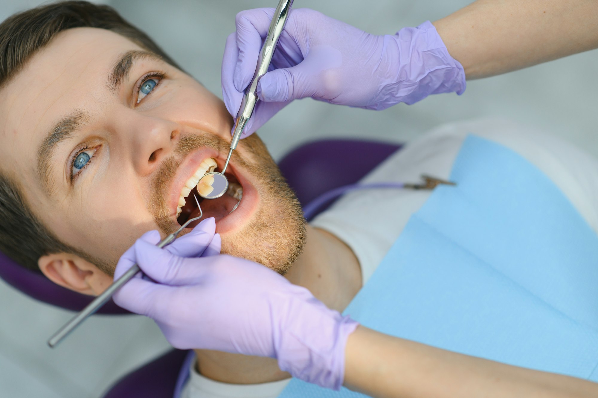 Periodontal Services. Closeup Shot Of Smiling Man Getting Treatment In Stomatologic Clinic